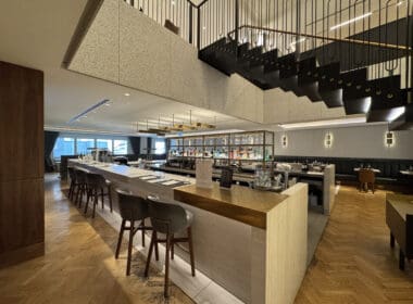 a bar with chairs and a staircase