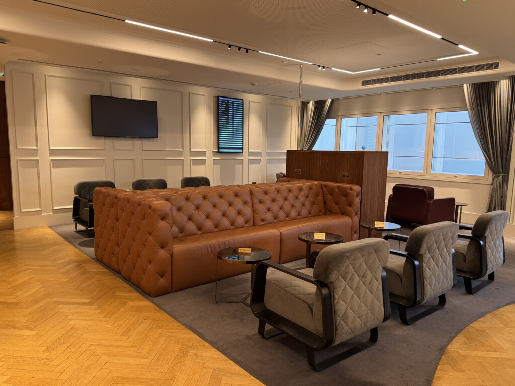 a room with a couch and chairs