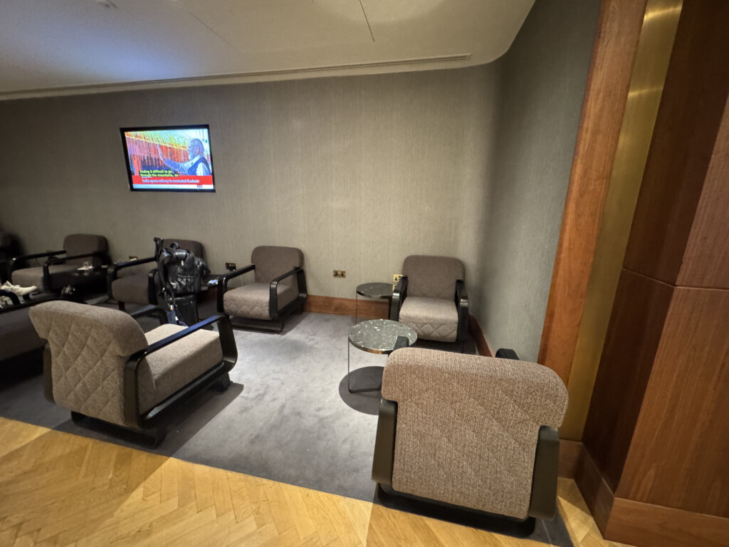 a room with chairs and a television