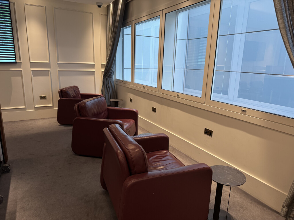 a room with red chairs and a table