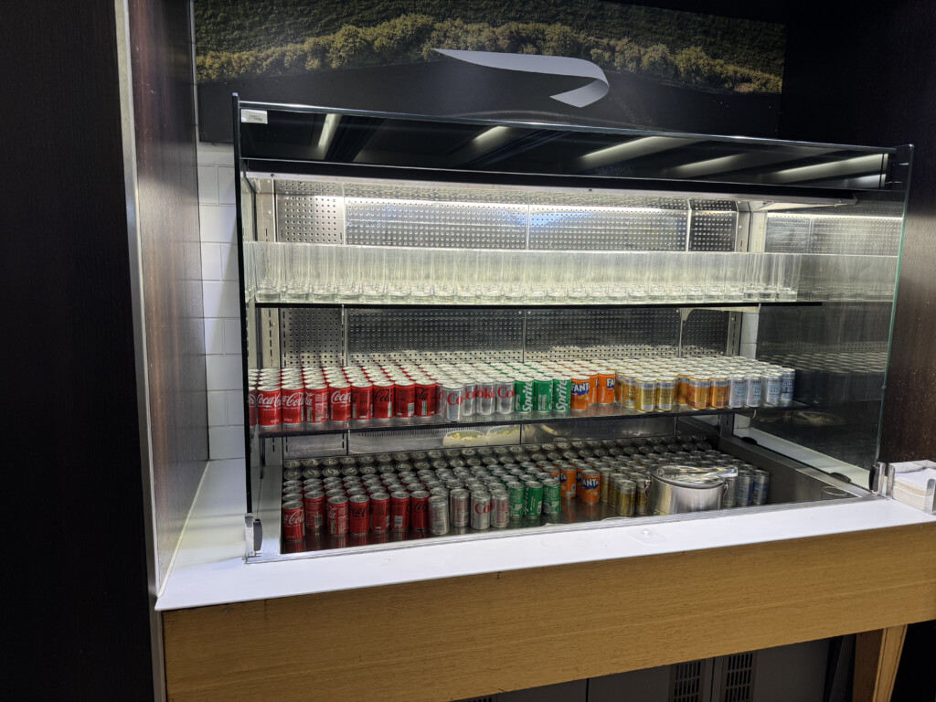 a display case with drinks and glasses