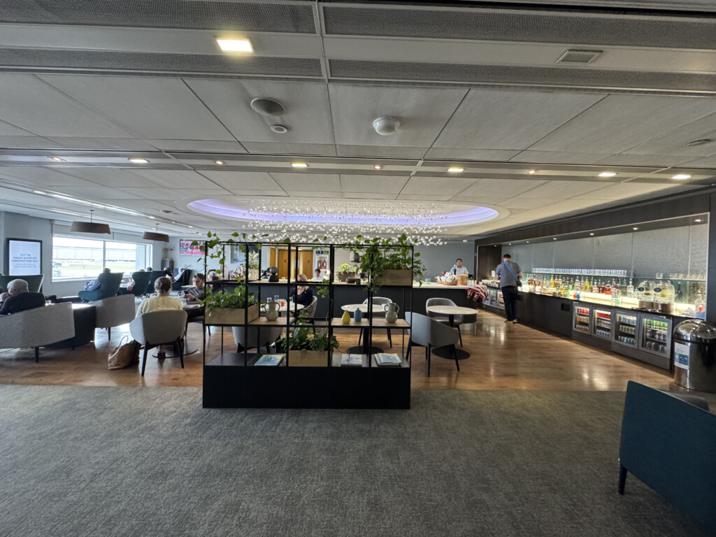 a room with tables and chairs and people in it