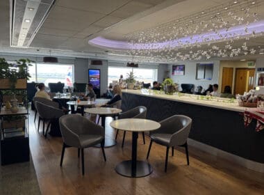 a group of people sitting at tables in a room with a large window