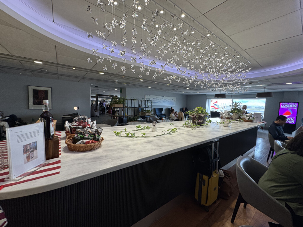 a long counter with lights from the ceiling