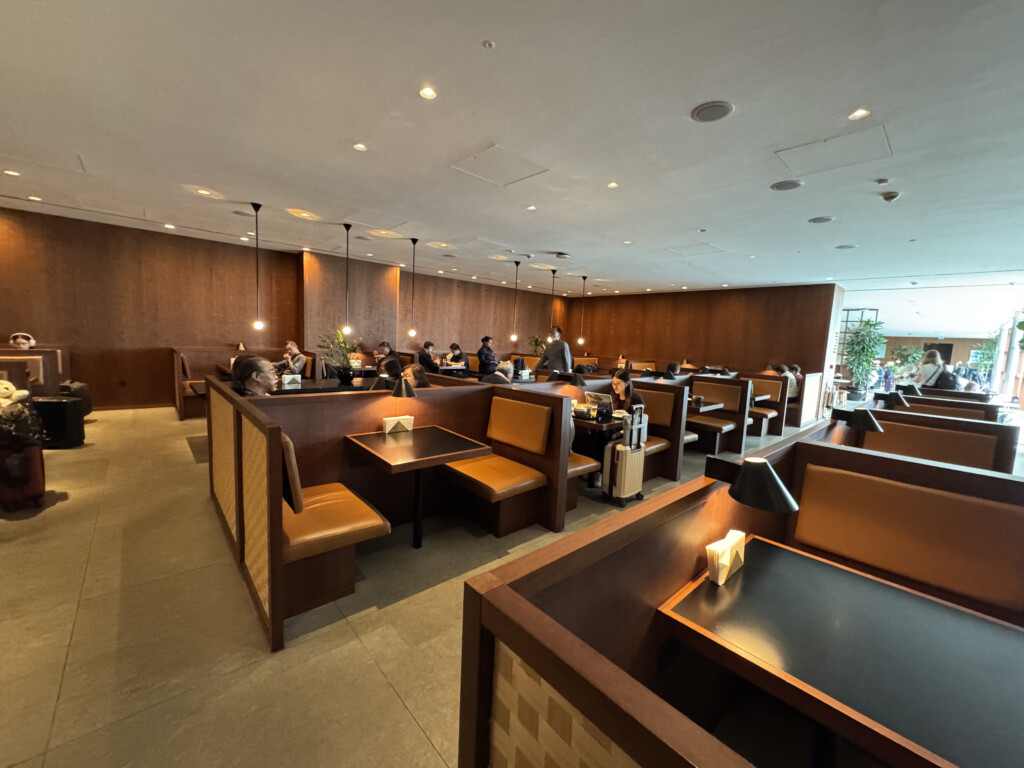 a room with tables and chairs and people sitting at tables