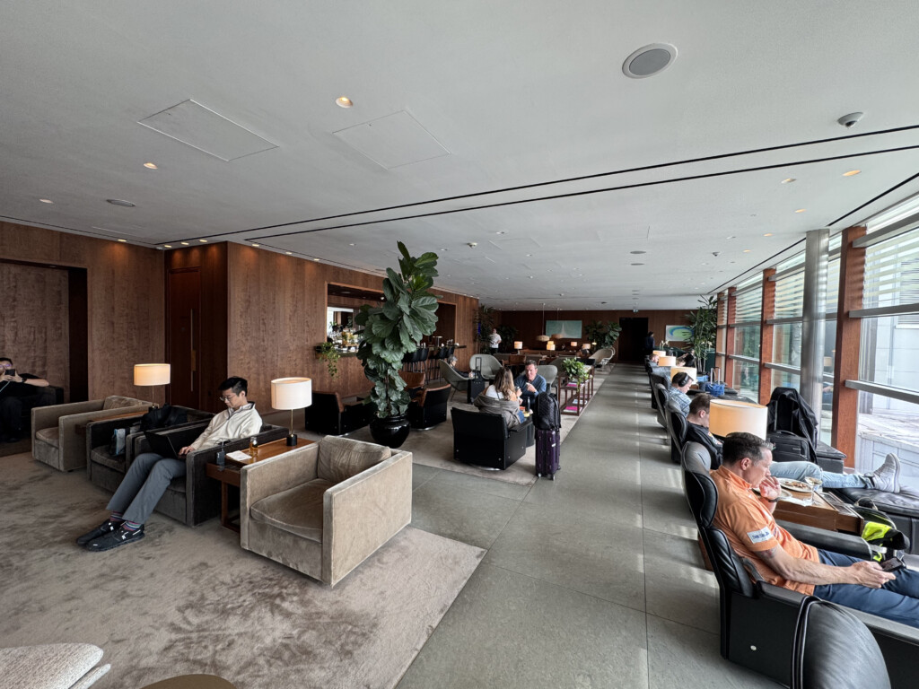 a group of people sitting in a room with windows