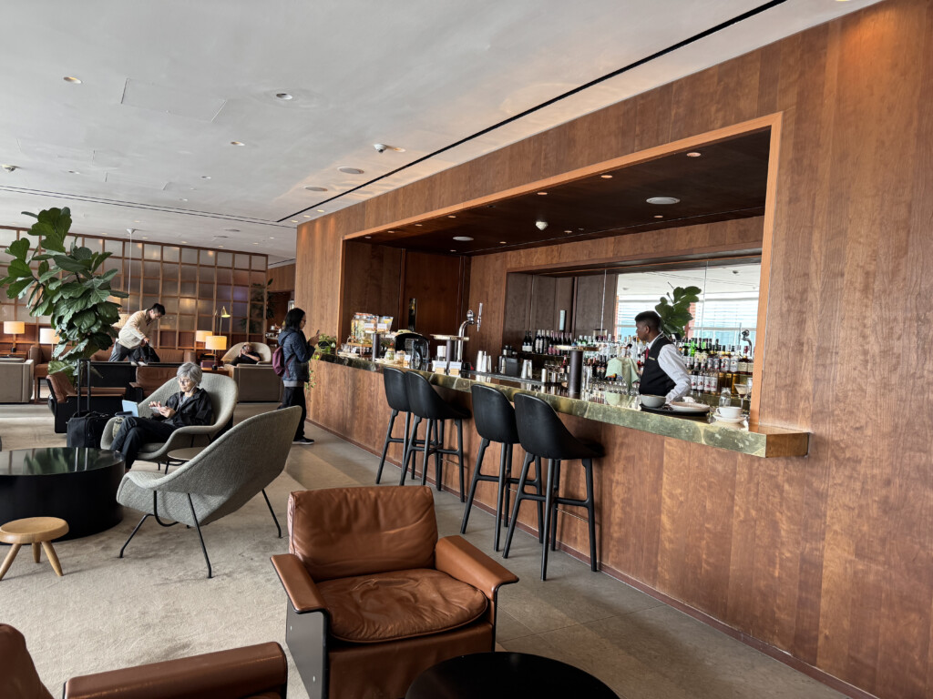 a bar with people sitting at the counter