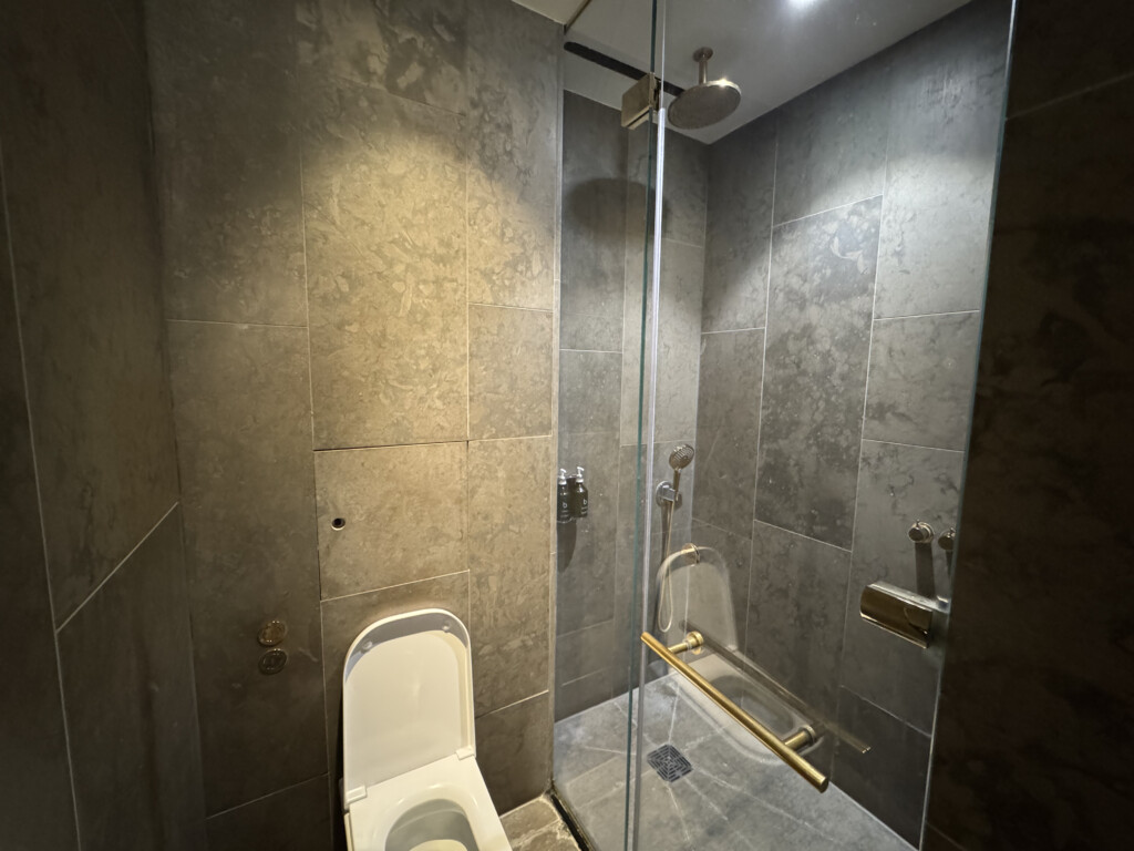 a bathroom with a glass shower door