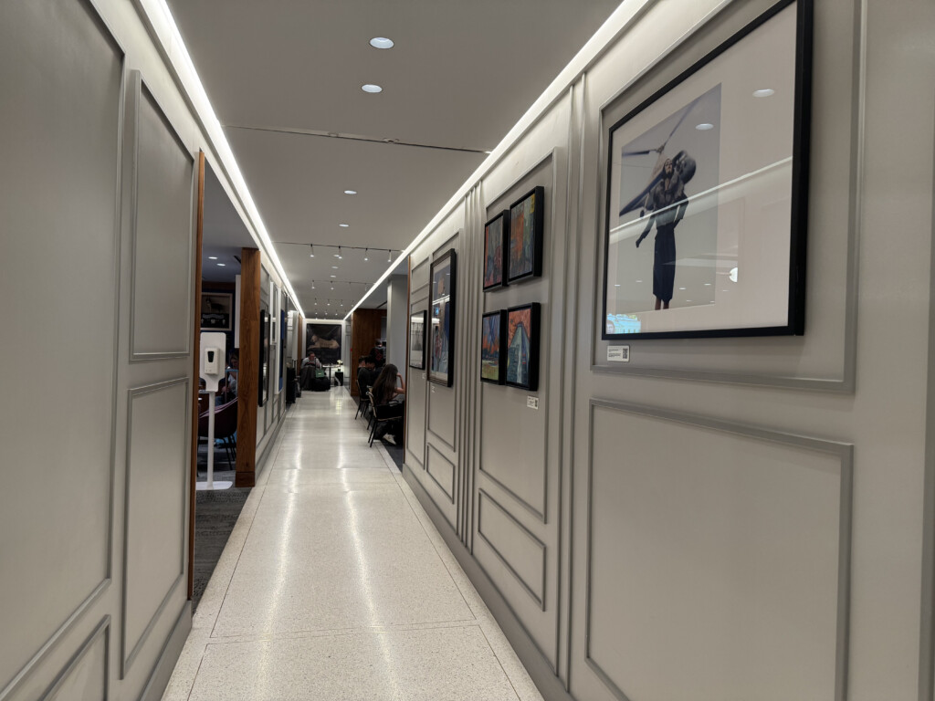 a hallway with pictures on the wall