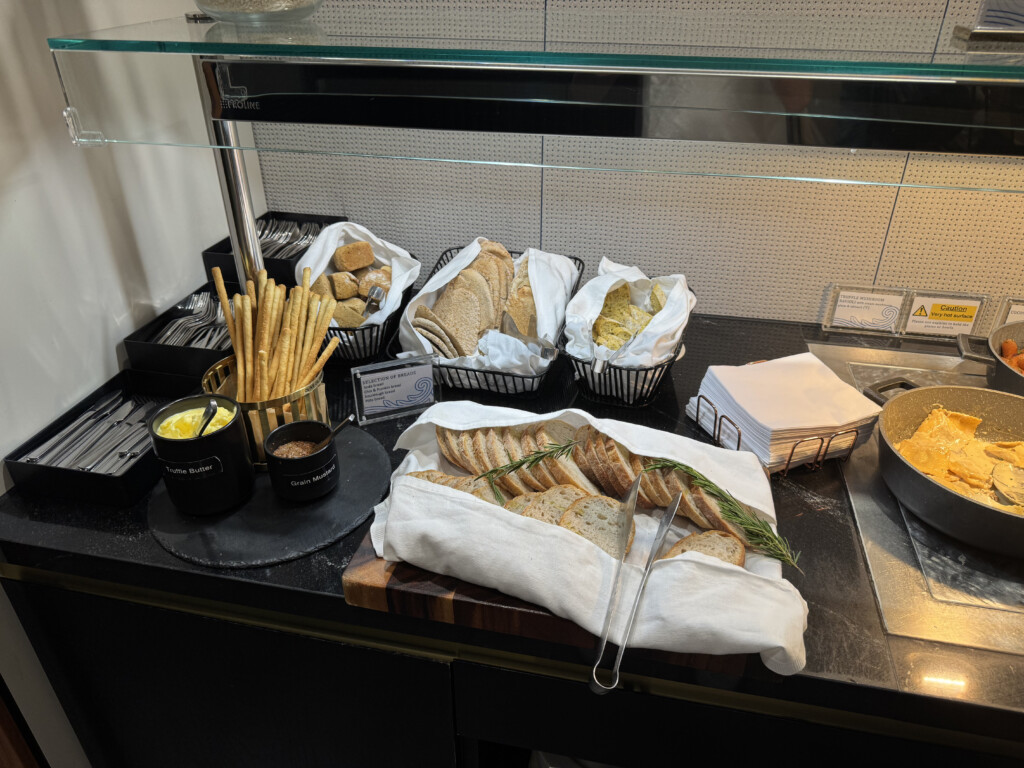 a buffet table with bread and other food items