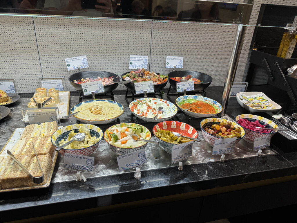 a buffet table with bowls of food