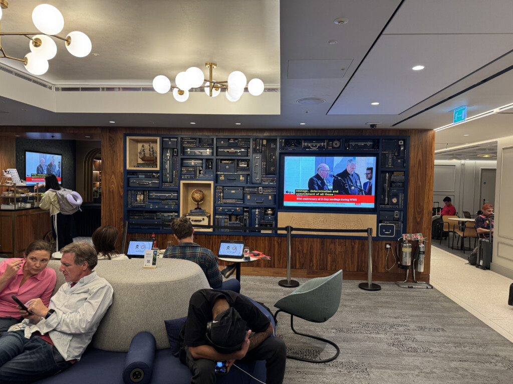 a group of people sitting in a room with a television