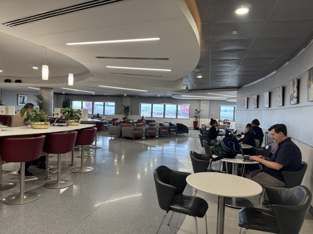 a group of people sitting at tables in a room with chairs and tables