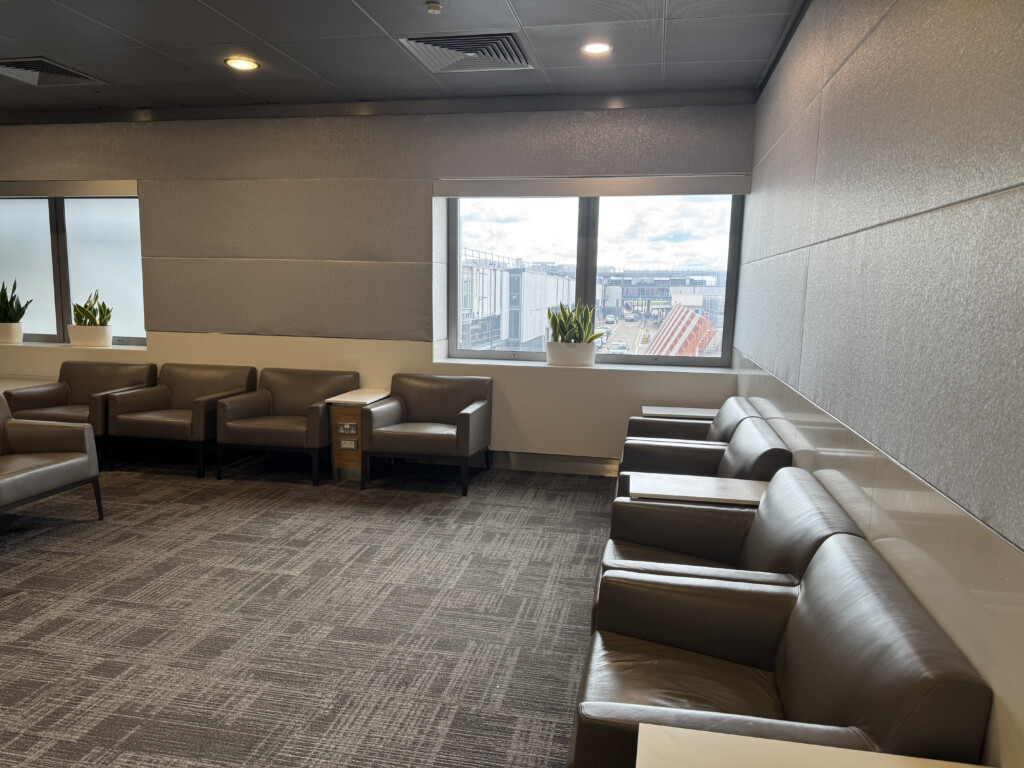 a room with chairs and a window