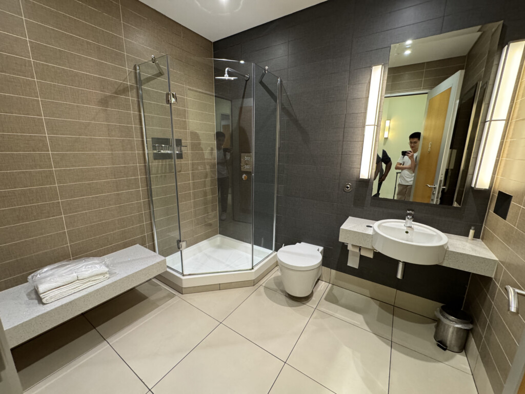 a bathroom with a shower and sink