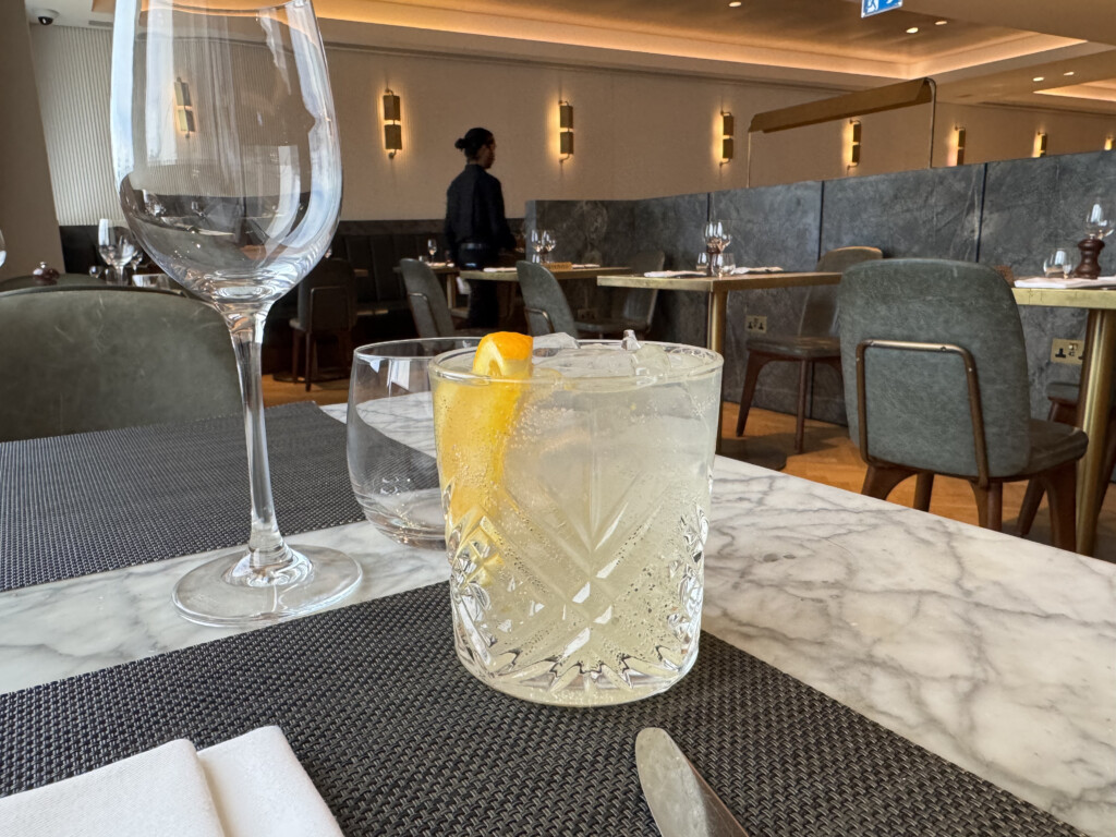 a glass of water with a lemon on a table