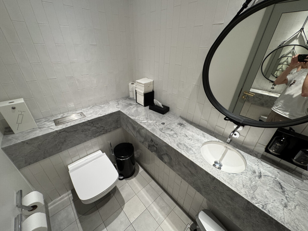 a bathroom with a round mirror