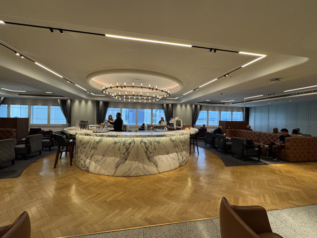 a room with a large round counter and chairs