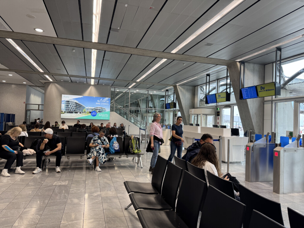 people sitting in chairs in an airport