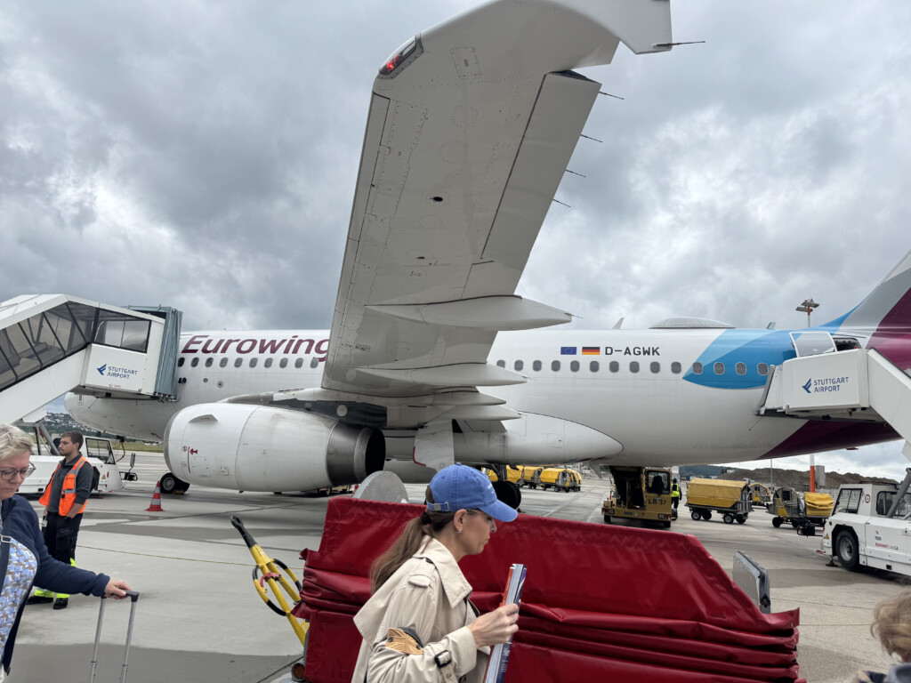 a woman standing in front of an airplane
