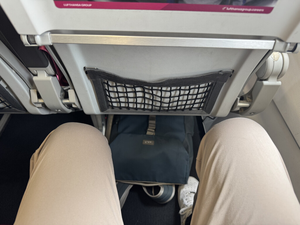 a person's legs in a plane
