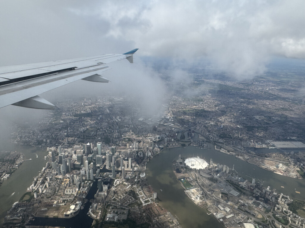 an airplane wing and city view from the sky
