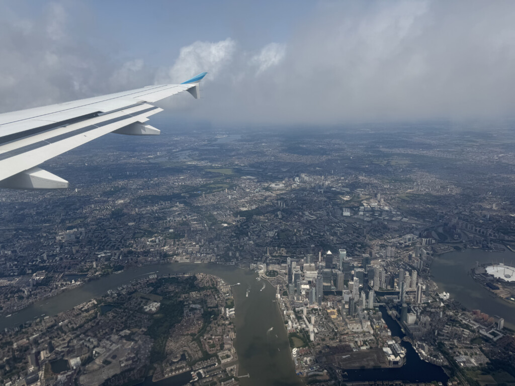 an airplane wing and city view from an airplane window