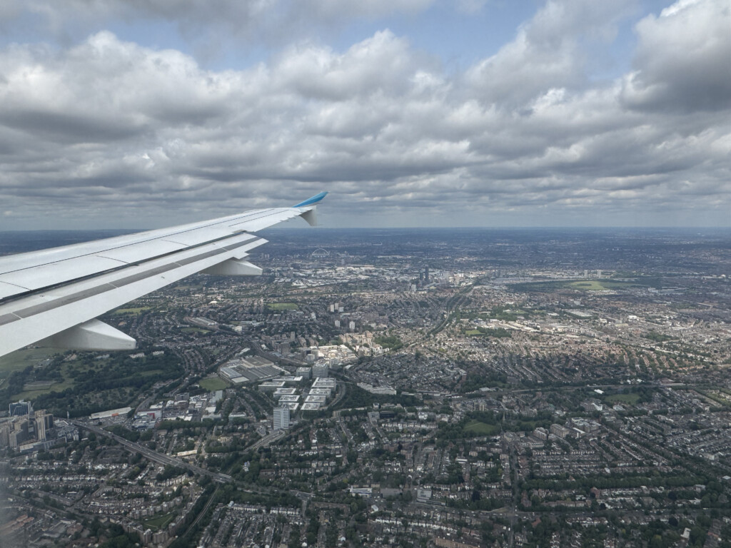 an airplane wing and city below