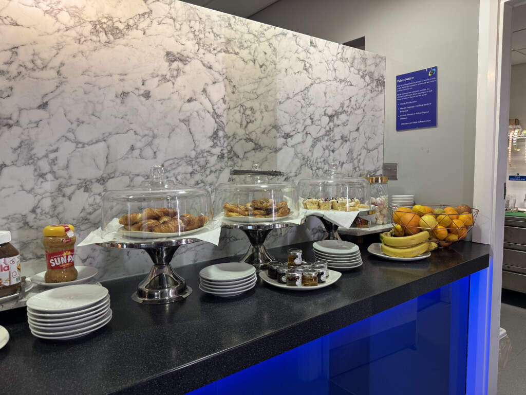 a buffet table with plates of food and fruit