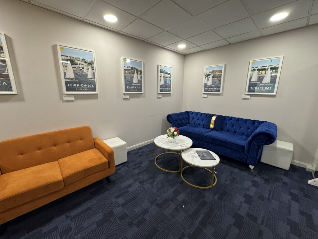 a room with couches and pictures on the wall