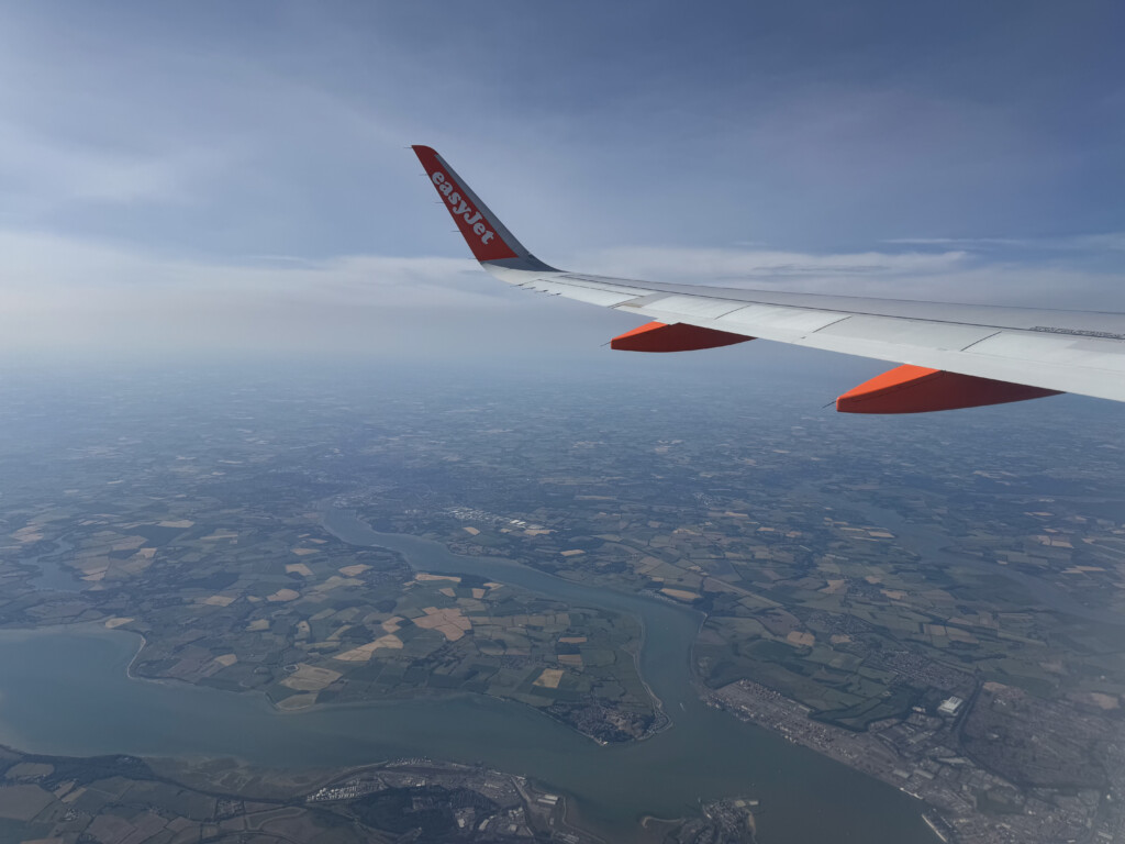 an airplane wing above a river