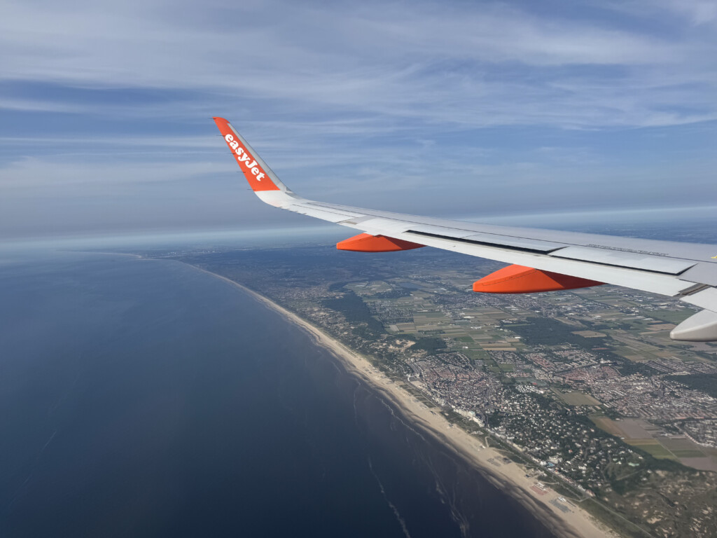 an airplane wing above a body of water
