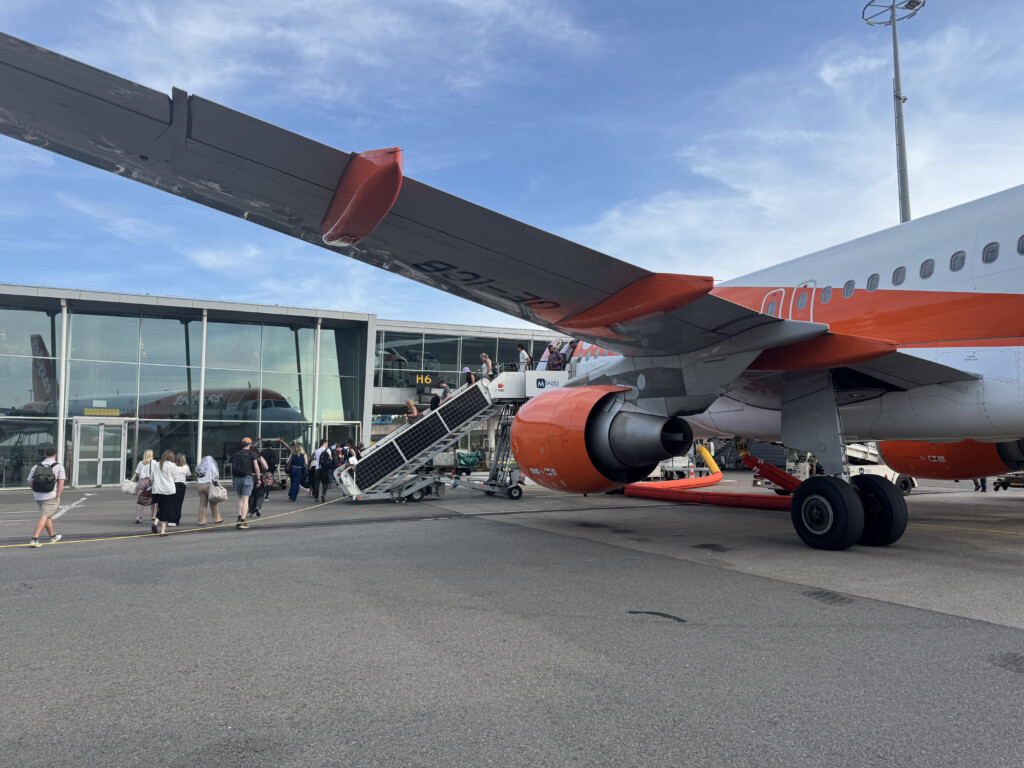 a group of people walking by an airplane