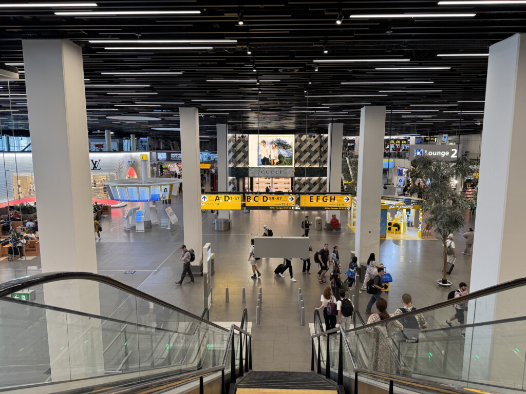 a group of people walking down an escalator