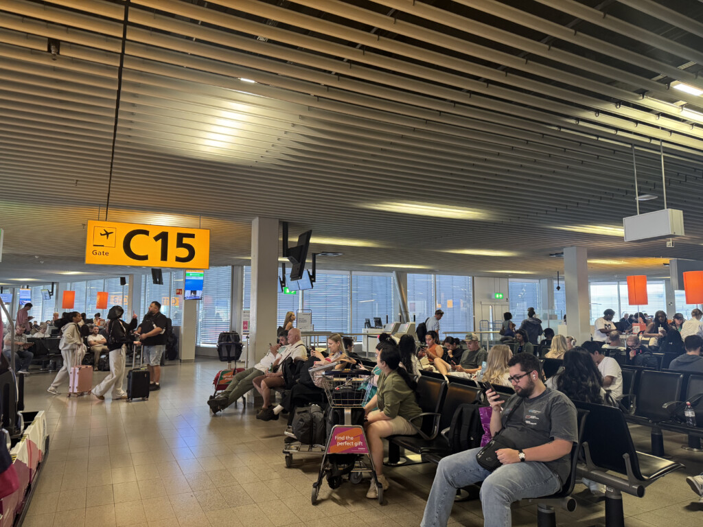 a group of people sitting at tables in an airport