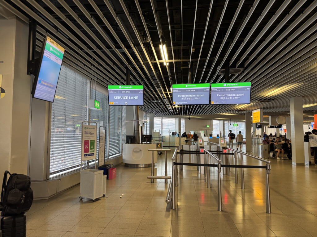 a airport with signs and luggage