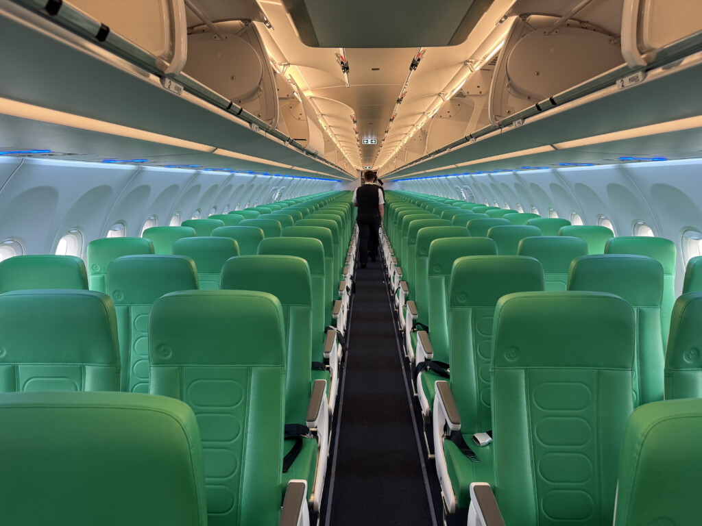 a row of green seats in an airplane