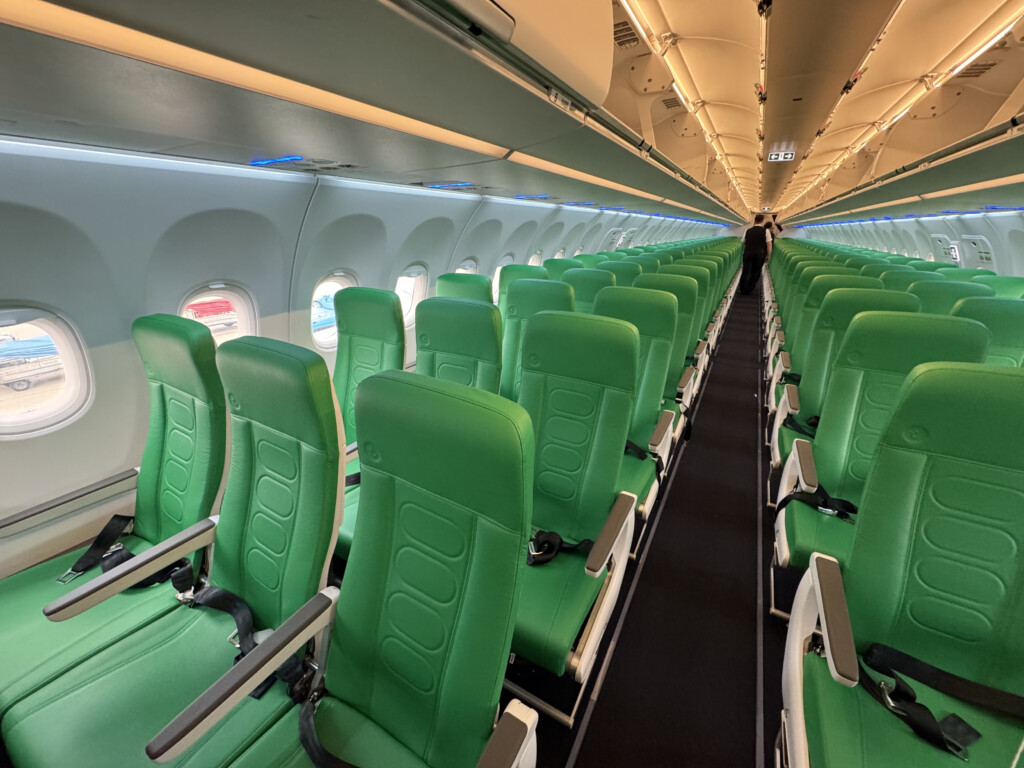 a row of green seats in an airplane