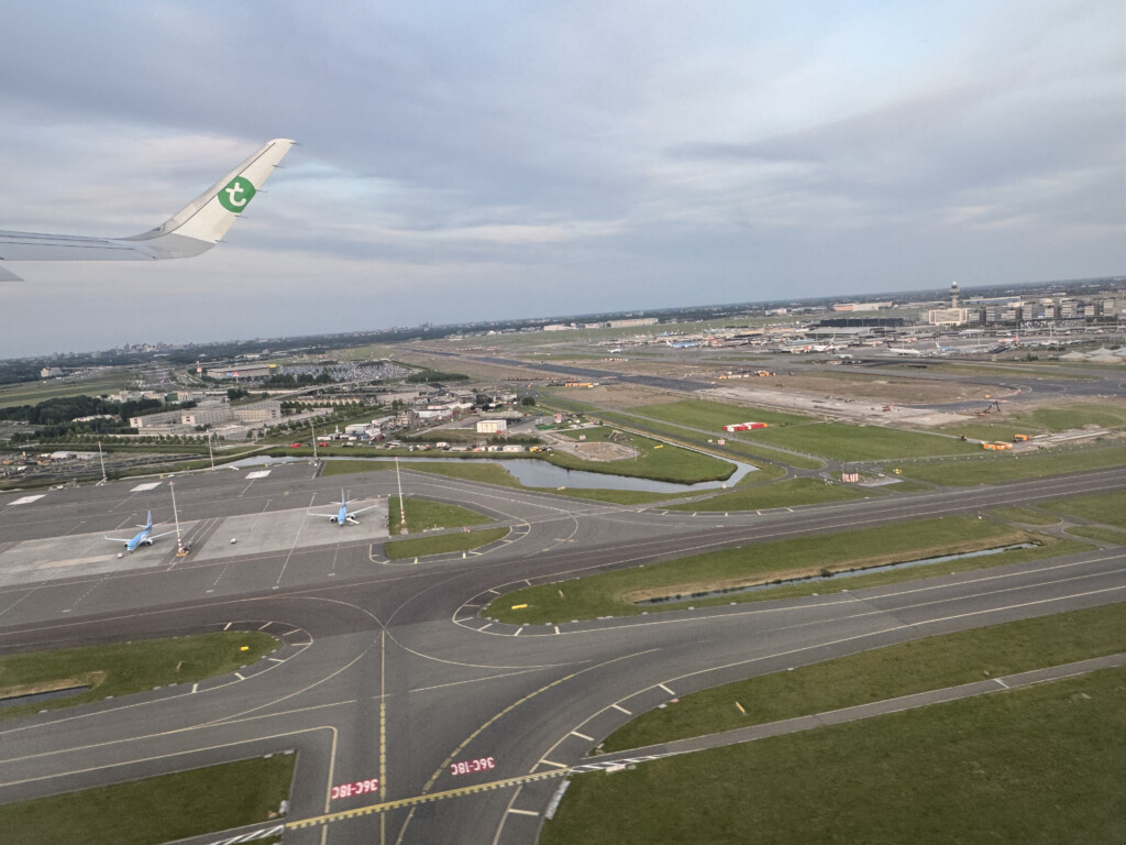 an airplane flying over a runway