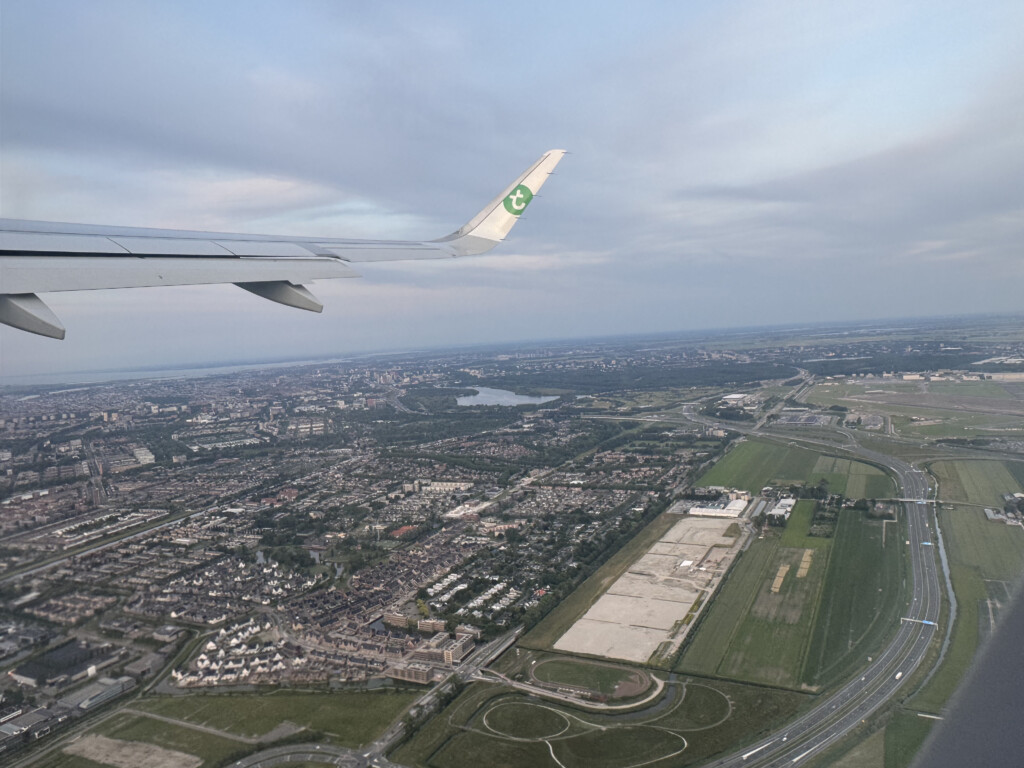 an airplane wing above a city