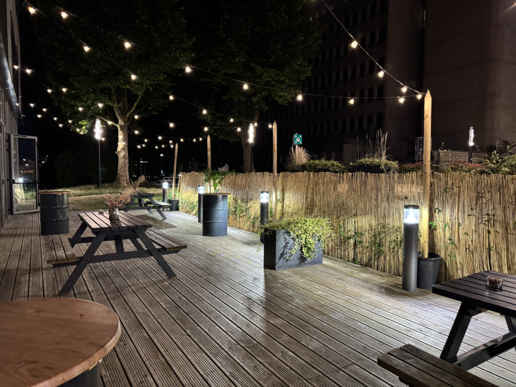 a patio with a fence and trees