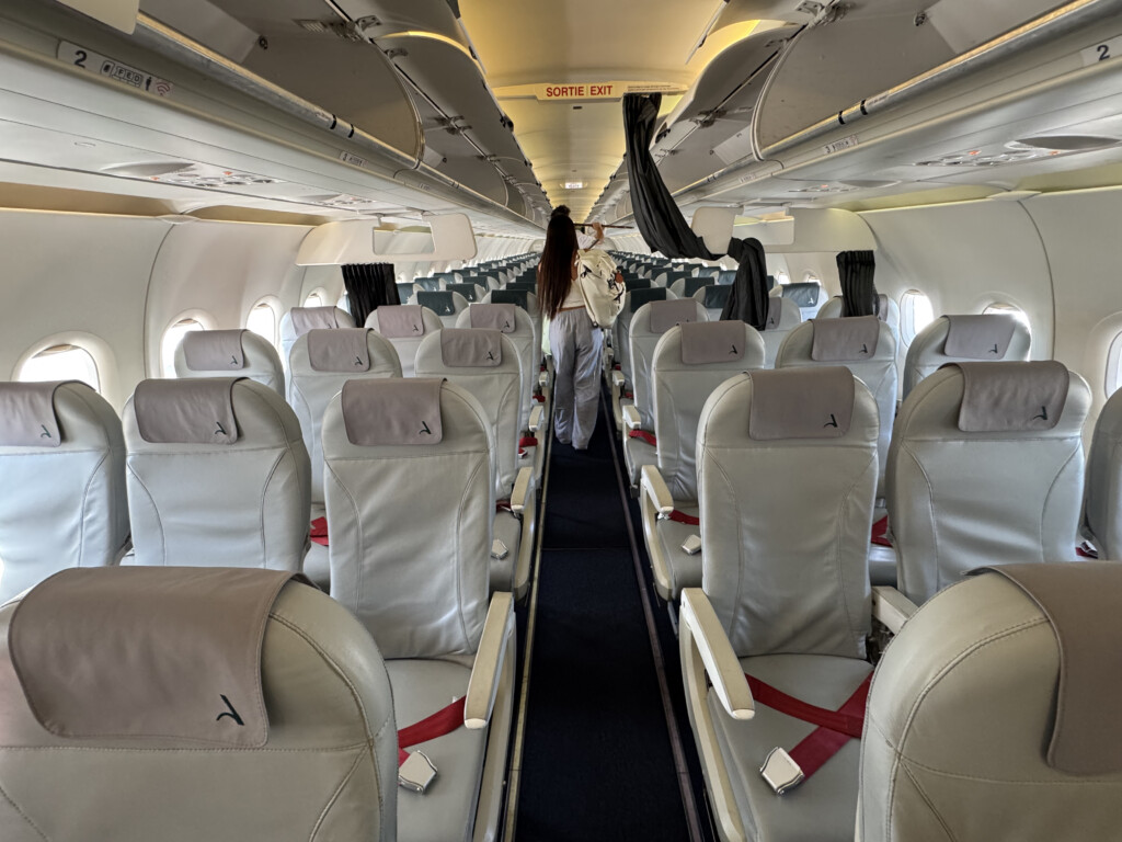 a person standing in the aisle of an airplane