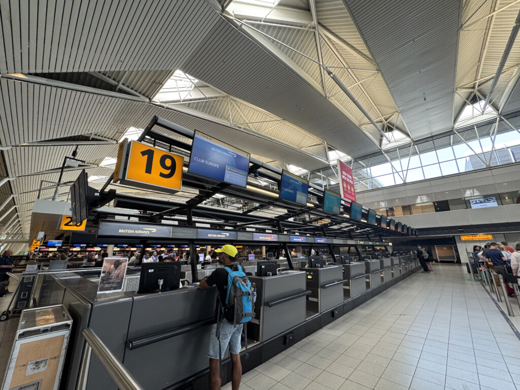 a person standing at a counter in an airport