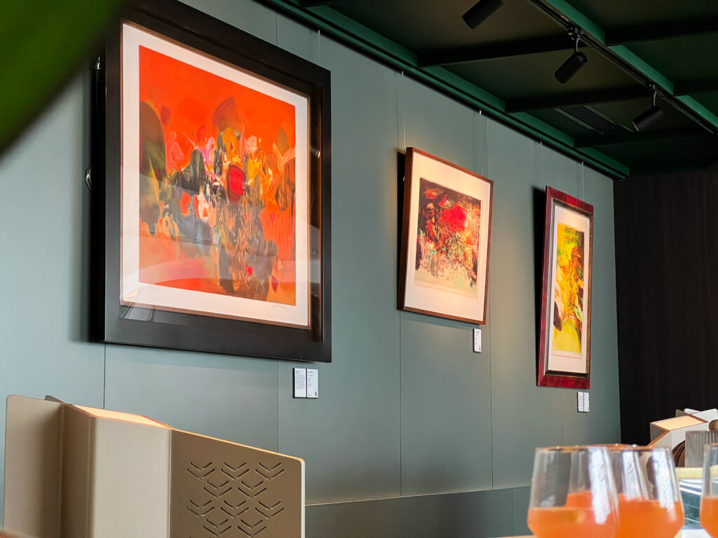 a group of framed pictures on a wall