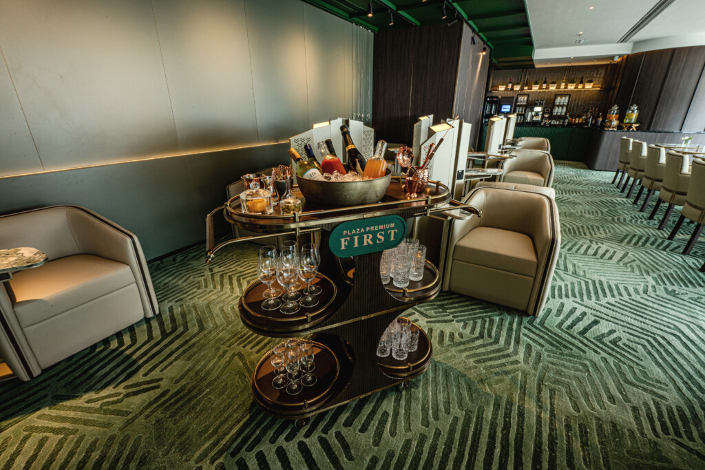 a room with chairs and a table with drinks