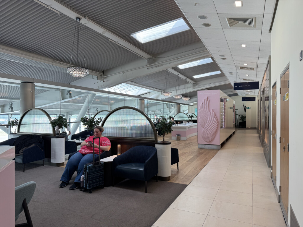 a woman sitting in a chair in a lobby