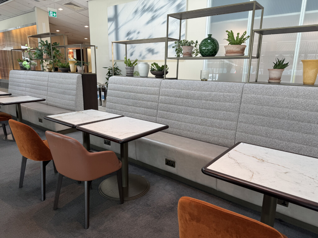 a booth seating with tables and chairs