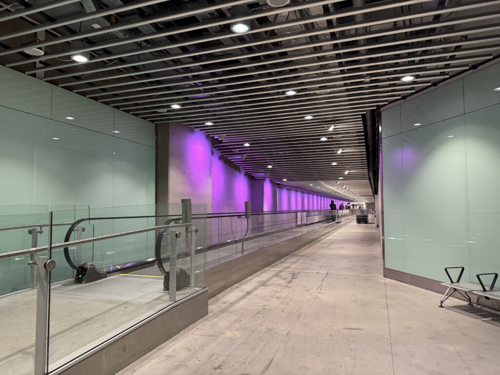 a walkway with a glass railing