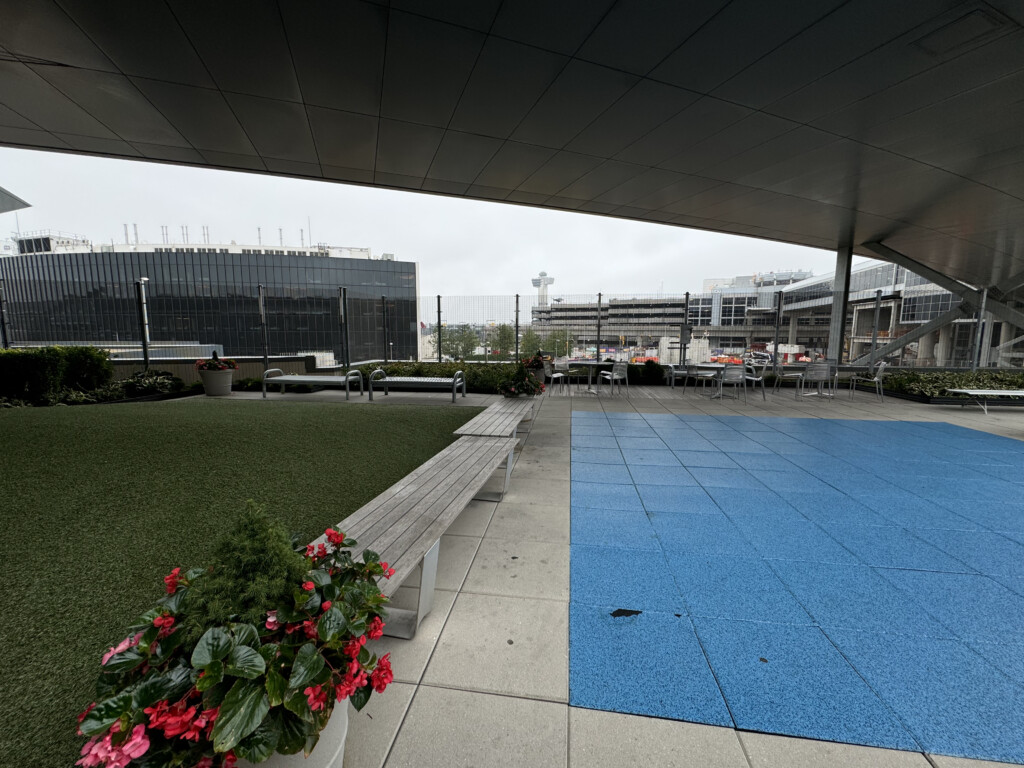a blue and blue area with benches and grass