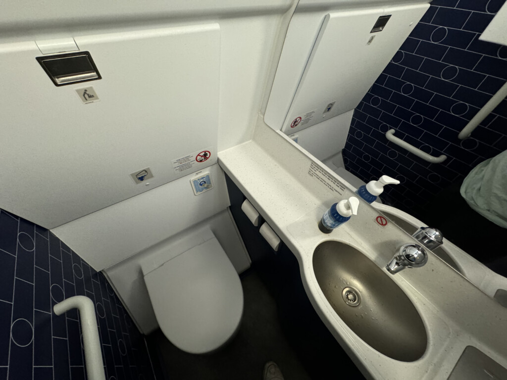 a bathroom with a sink and soap dispenser